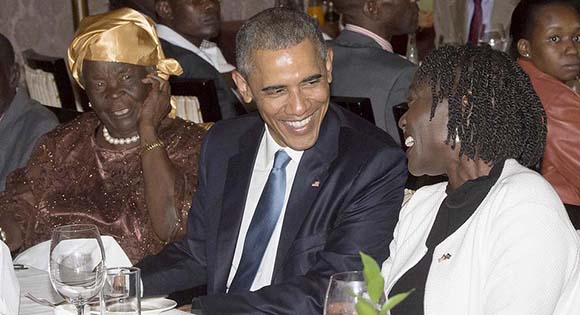 US President Barack Obama sits alongside his step-grandmother, Mama Sarah (L) and half-sister Auma Obama (R), during a gathering of family at his hotel in Nairobi, Kenya, July 24, 2015.  US President Barack Obama arrived in the Kenyan capital Nairobi late Friday, making his first visit to the country of his father's birth since his election as president. Obama was greeted by Kenyan President Uhuru Kenyatta with a handshake and embrace as he stepped off Air Force One, at the start of a weekend visit during which he will address an entrepreneurship summit and hold talks on trade and investment, counter-terrorism, democracy and human rights.  AFP PHOTO / SAUL LOEB        (Photo credit should read SAUL LOEB/AFP/Getty Images)